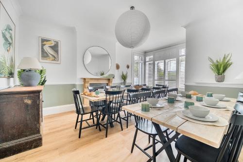 a dining room with a table and chairs at Palm House in Newquay