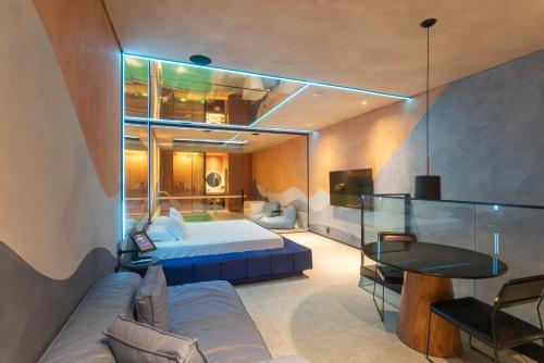 a hotel room with a bed and a table at Lush Motel Lapa in Sao Paulo