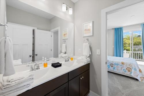 a bathroom with a sink and a large mirror at 5br Beauty Near Bethany-community Pool Linens in Ocean View
