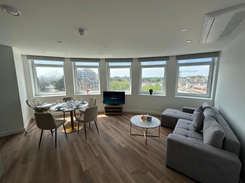 a living room with a couch and a table at Bournemouth Lookout in Bournemouth