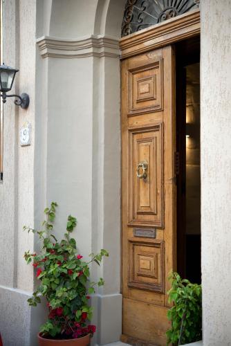 a wooden door of a building with two potted plants at Sliema 5-bedroom Town House in Sliema