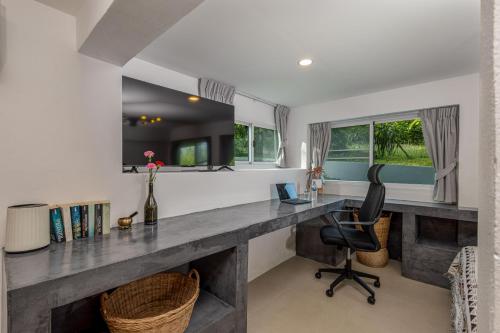 a home office with a desk and a chair at BOHO Boutique Bungalows in Baan Tai