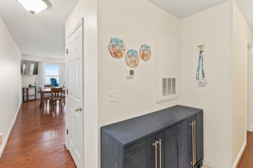 a kitchen with white walls and a black cabinet at Unbelievable Beach Views For 6 in North Beach