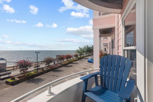 a blue chair sitting on a balcony looking out at the ocean at Unbelievable Beach Views For 6 in North Beach