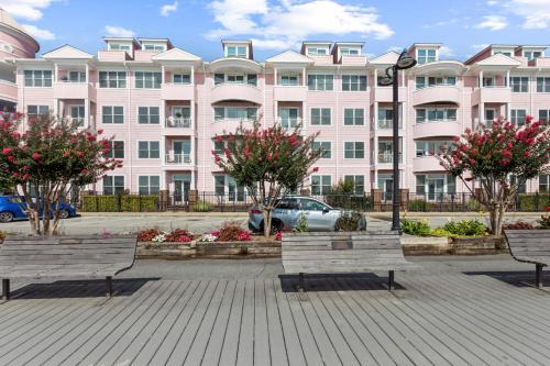 a large pink building with benches in front of it at Unbelievable Beach Views For 6 in North Beach