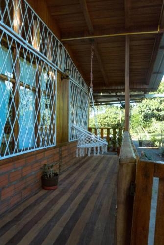 a porch of a house with a wooden floor at Family villa in Puyo in Tarqui