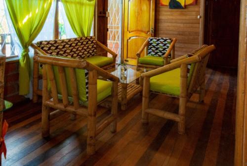 a dining room with two chairs and a table at Family villa in Puyo in Tarqui