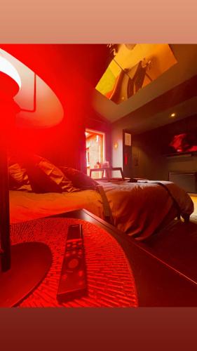 a bedroom with a bed with a red light at Roomantic spa 