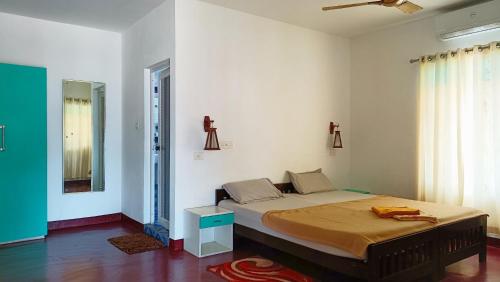 a bedroom with a large bed in a room at Marari Praise Beachfront Homestay in Mararikulam