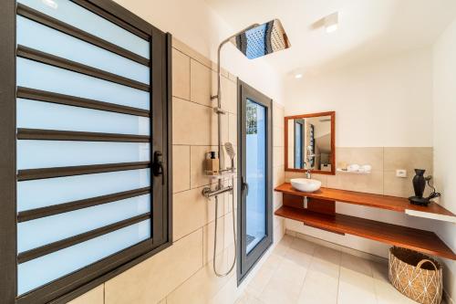 a bathroom with a sink and a window at Les Horizons de Grand Fond in Saint-Gilles les Bains