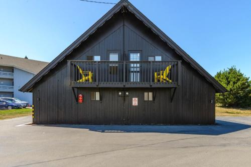 a black building with yellow chairs on a balcony at Tidal House #2 in Ocean Shores