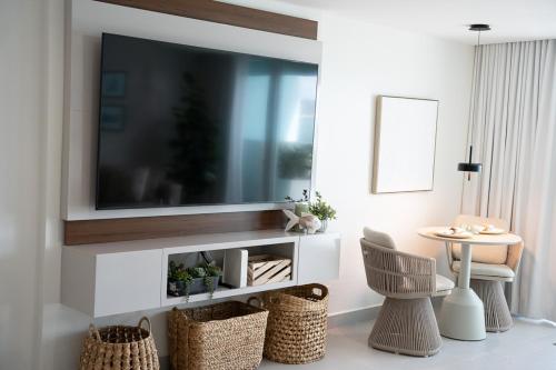 a living room with a television on a wall at Seaside Cove Studio-Completely Renovated! in Fajardo