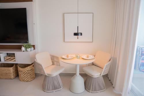 a dining room with a table and two chairs at Seaside Cove Studio-Completely Renovated! in Fajardo
