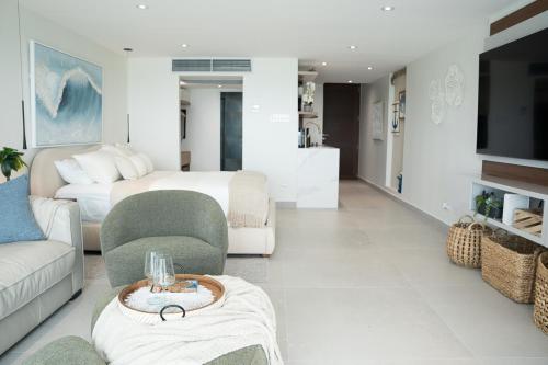 a living room with a couch and a bed at Seaside Cove Studio-Completely Renovated! in Fajardo