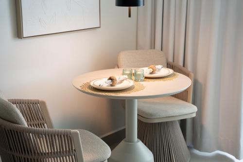 a small table with two plates of food on it at Seaside Cove Studio-Completely Renovated! in Fajardo