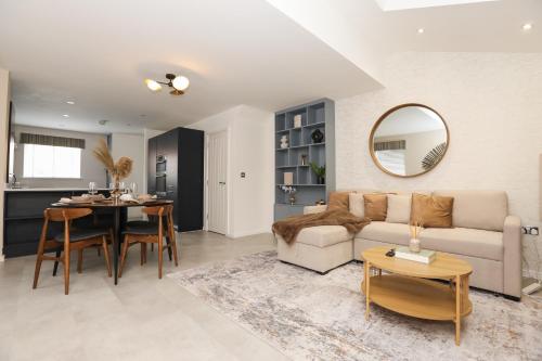 a living room with a couch and a table at The Scenic Luxury House in Manchester