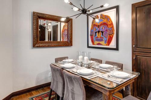 a dining room with a table and a mirror at LIFT LODGE 102 condo in Park City