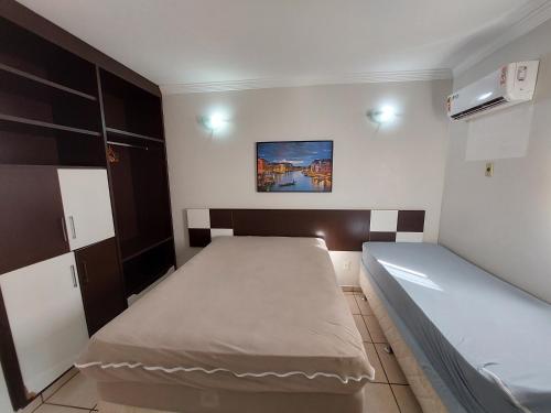 a small bedroom with a bed at diRoma Fiori - Apartamentos JN in Caldas Novas