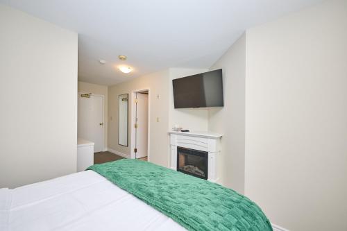 a bedroom with a bed and a fireplace at Nine Vines Hotel in Niagara on the Lake