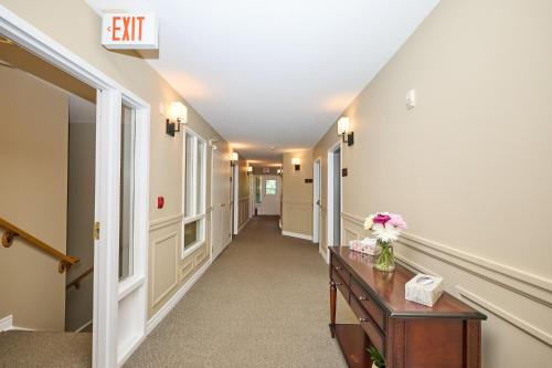 an empty hallway of a hospital with a table and flowers at Nine Vines Hotel in Niagara on the Lake