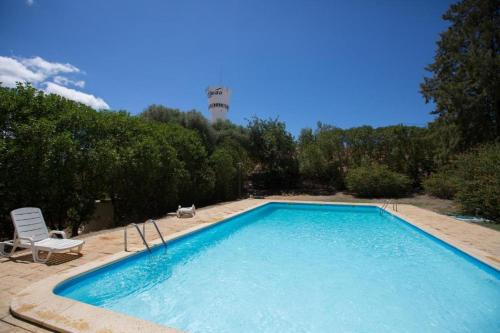 a large swimming pool with a chair and a chair at HI Portimão - Pousada de Juventude in Portimão