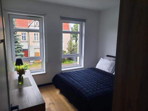 Postel nebo postele na pokoji v ubytování APARTAMENT KOŚCIUSZKi 54