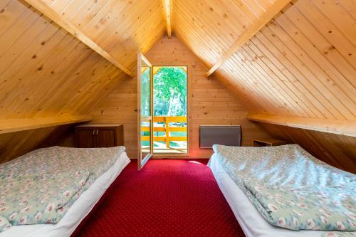 Postel nebo postele na pokoji v ubytování Domki Letniskowe Neptun