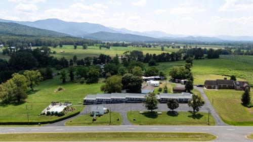 an aerial view of a farm with mountains in the background at Hillside Hotel in Luray