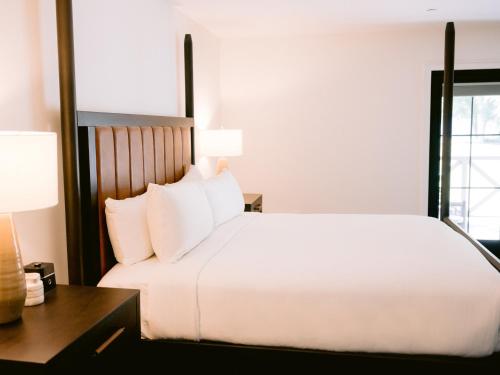a bedroom with a large white bed and a desk at Homestead Resort in Midway