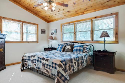 a bedroom with a bed and a wooden ceiling at Boujee Bear Lodge - A Peaceful Cabin in the Woods in Morganton