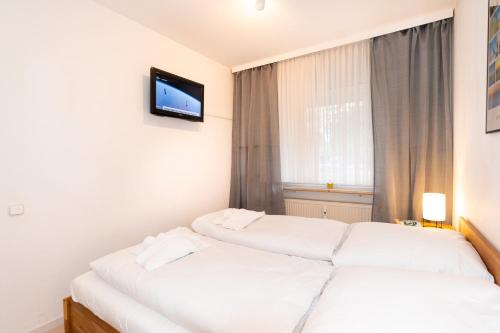 Postel nebo postele na pokoji v ubytování Hanseat II Whg 101