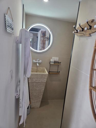 a bathroom with a sink and a mirror at Le studi'eau in Ferques