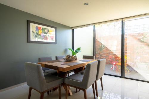 a dining room with a wooden table and chairs at Residencia Galicia Family in Guadalajara