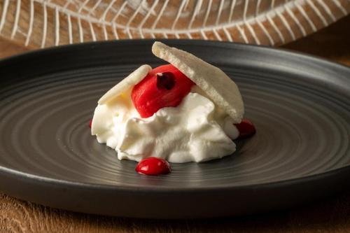 a dessert on a plate with a piece of fruit at Casa As Fontes in Porqueirós