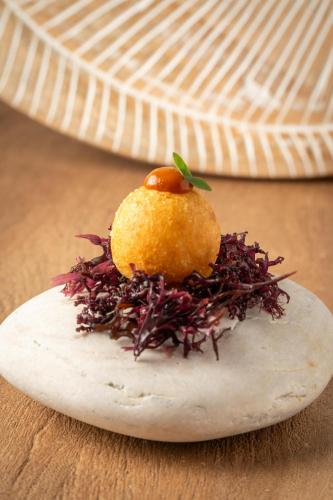 a piece of food on a plate on a table at Casa As Fontes in Porqueirós