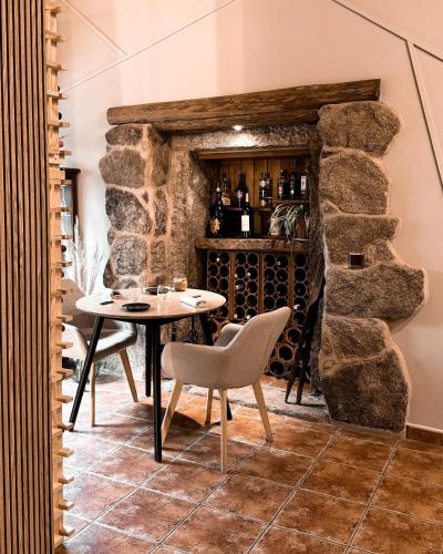 a dining room with a table and a wine cellar at Casa As Fontes in Porqueirós