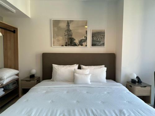 a bedroom with a large bed with white pillows at Downtown Miami view - 38th floor gem in Miami