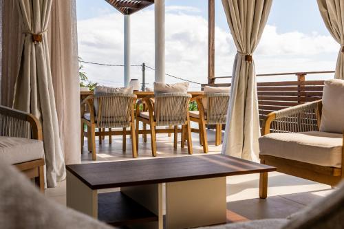 a living room with a table and chairs at Les Horizons de Grand Fond in Saint-Gilles les Bains
