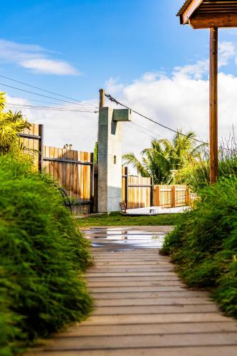 a wooden walkway with a gate and a fence at Les Horizons de Grand Fond in Saint-Gilles les Bains