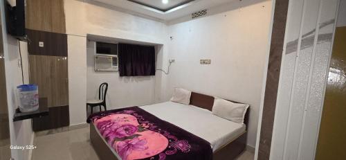a small bedroom with a small bed in it at Vishwanath Palace in Deoghar