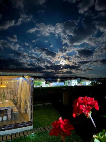 a view of a tent with flowers in the grass at Stenata LightWill in Banya
