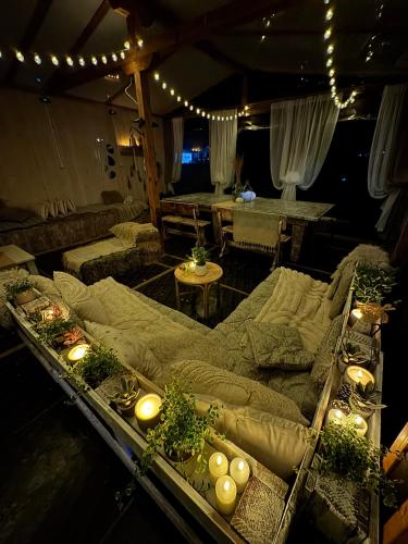 a living room with two couches and a table with lights at Stenata LightWill in Banya