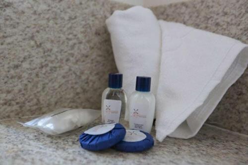 two bottles of soap and a roll of paper towels at Hotel Amsterdam Montes Claros in Montes Claros