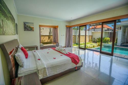 a bedroom with a large bed and a swimming pool at 1BR Private Pool Villa in Seminyak PB in Seminyak