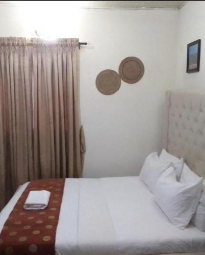a hotel room with a bed and a window at DE LIGHT HOUSE Hotel lekki phasa 1 in Lagos