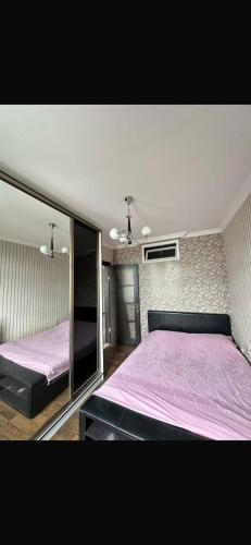a bedroom with two beds with purple sheets at vox in Itʼkhvisi