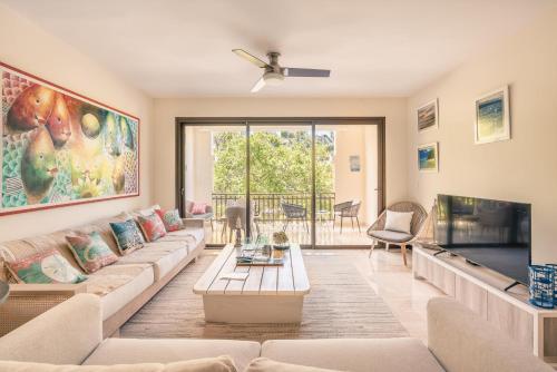 a living room with a couch and a tv at Apartment with 2bedrooms in Portillo Residences in Abra Grande