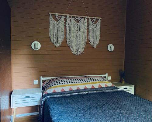 a bedroom with a bed with a wooden wall at ПростоРа in Khalepʼye