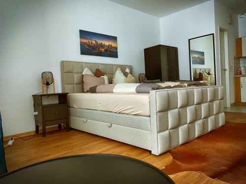 a bedroom with a large bed and a mirror at Talgarten Studio 8 in Erfurt