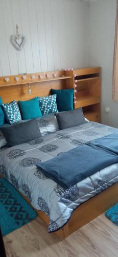 a bedroom with a large bed with blue pillows at Privat Ludmila in Liptovská Teplička
